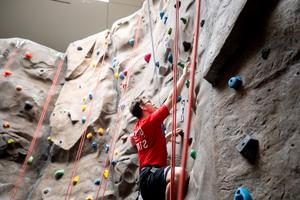 Student climbing the rock wall